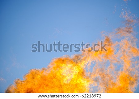 Flames reach into the sky from a propane fire.