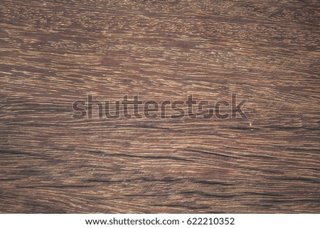 Grungy cracked wooden board by closeup textured background