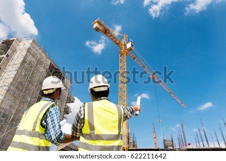 Construction engineers discussion with architects at construction site or building site of highrise building Royalty-Free Stock Photo #622211642