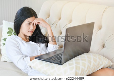 Beautiful young women using a computer in the room at home relax time on holiday