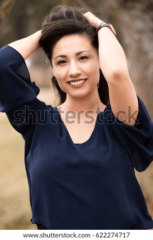 asian woman outdoor smiling to camera