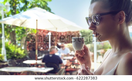 Young woman drinking coffee in hotel terrace