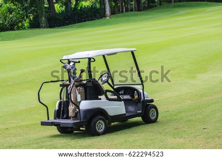 Golf cart in the green lawn