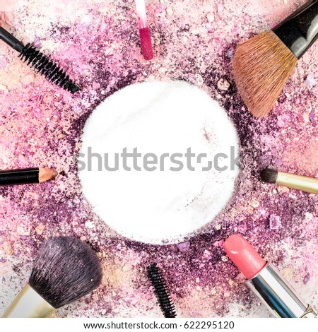 Makeup brushes, pencil, lipstick and other objects, forming a frame on a light background, with crushed powder and copy space. A square template for a makeup artist's business card or flyer design