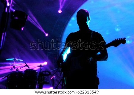 Guitarist and concert lights Royalty-Free Stock Photo #622313549