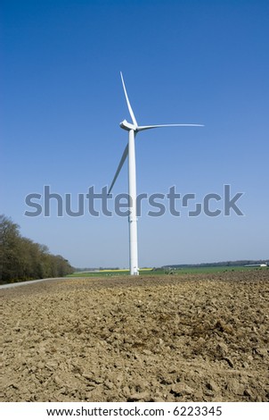 Wind Turbine with soil in foreground. Vertical view.