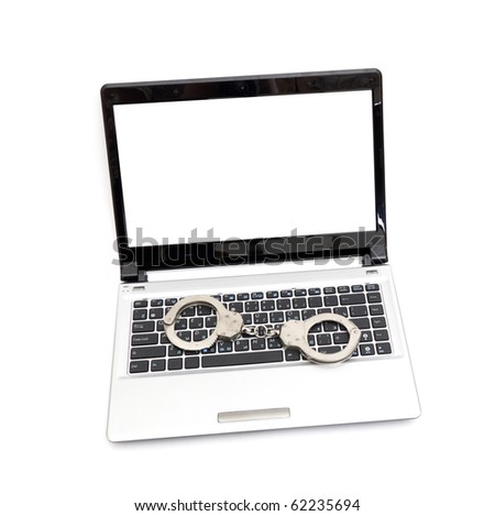 Handcuffs is on the laptop keyboard. Computer/Internet crimes and internet addiction concept. Royalty-Free Stock Photo #62235694