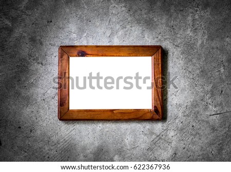 blank space wood picture frame on concrete wall 