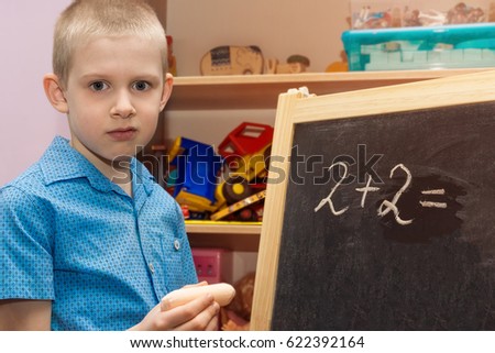 The picture shows a chalky boy on a blackboard