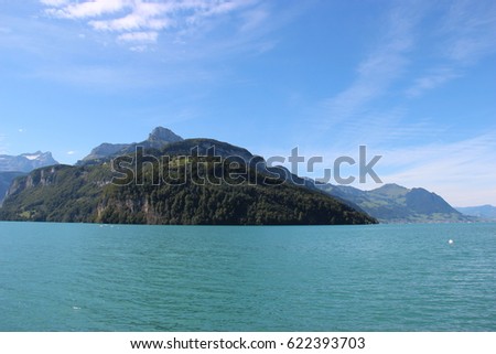 Lanscape with lake and montains from the water in Locarno, located at Ticino in Switzerland, during the summer in a sunny day