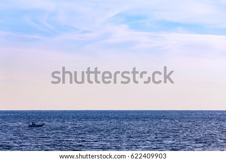 blue sea and sky with fishing boat