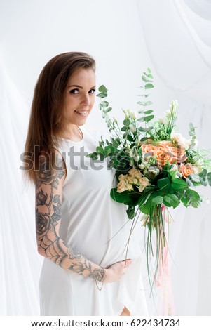 Beautiful pregnant girl with tattoo