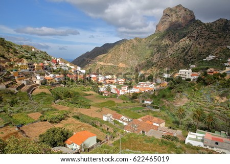 VALLEHERMOSO, LA GOMERA, SPAIN: General view of the valley with terraced fields and Roque Cano in the background. This picture was taken from a public walking trail.