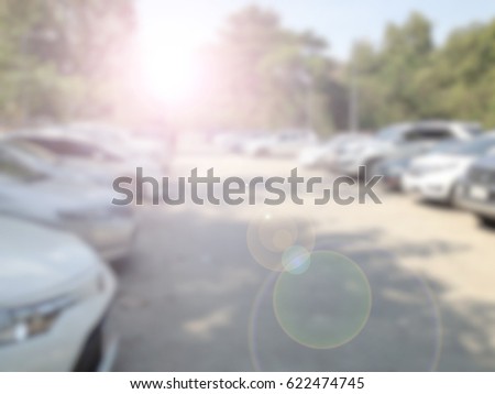 Blured image of cars in parking lot on day time