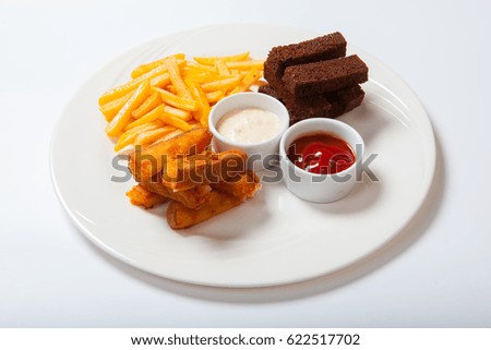 fish sticks with french fries on a white plate. White background