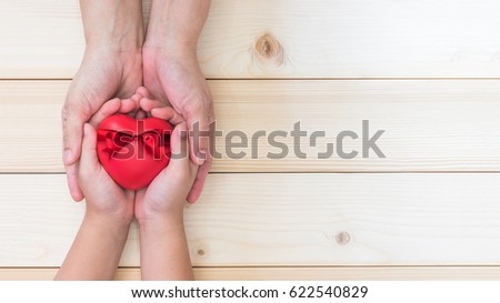 Happy Mother's day and love you Mom holiday greeting card with  woman support kid's hands giving red heart gift  Royalty-Free Stock Photo #622540829