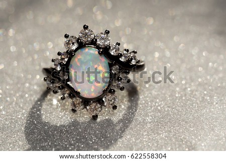Fashion ring decorated with white fire opal stones.