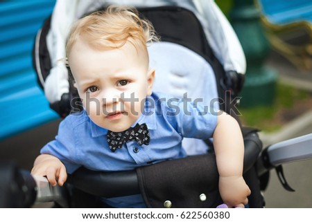 kid sitting in stroller. baby for a walk in a pram. spring outdoors. Child in buggy Little kid in pushchair. Transportation for family with infant Royalty-Free Stock Photo #622560380