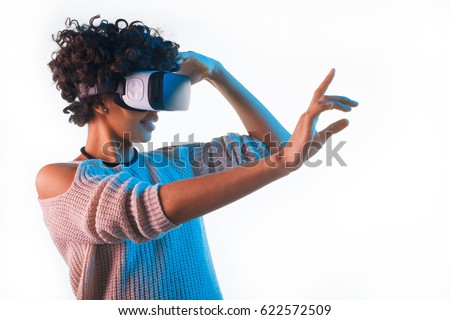 Beautiful woman touching air during the VR experience isolated on white. Royalty-Free Stock Photo #622572509
