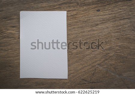 White paper note on the old wooden for background. Concept copy space background.