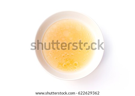 Bowl of chicken broth isolated on white background