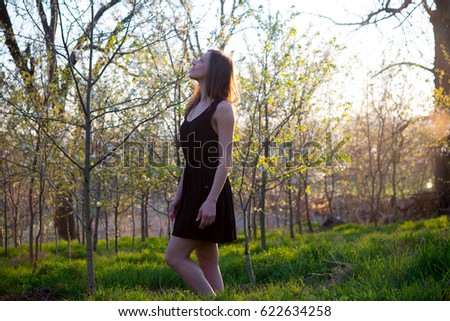 Beautiful brunette girl enjoy a spring garden with blossom