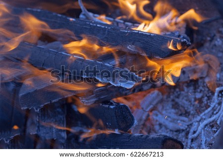 Hot charcoal with flame and ashes
