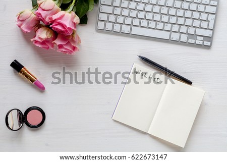 Woman white desk with roses and accessories 