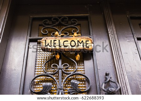 Wooden welcome sign on the door
