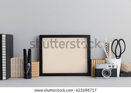 Photo frame on stylish desktop.