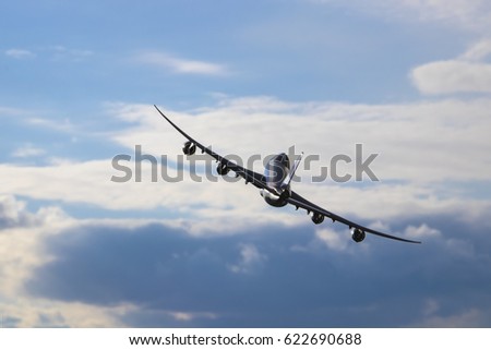 Airplane flying in the cloudy sky. Turn right. Boeing 747-8f. Royalty-Free Stock Photo #622690688