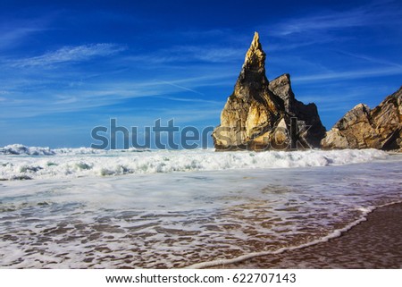Ocean beach. Panoramic view of huge cliff and ocean on the back. Waves crashing over rock formation cliffs. Dramatic scene. Beauty world landscape.