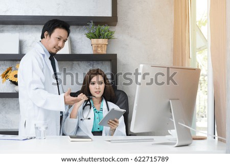 Two doctors work together with tablet and desktop, medical technology conceptual, doctor team coorperation conceptual
