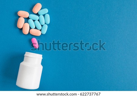 Cure for all diseases on a blue background. A bottle of pills