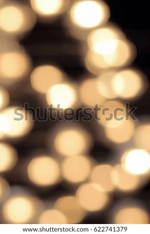 golden bokeh on a black background, abstract dark backdrop with defocused warm lights