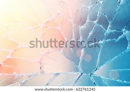 Broken glass with cracks in the sunlight, background, texture