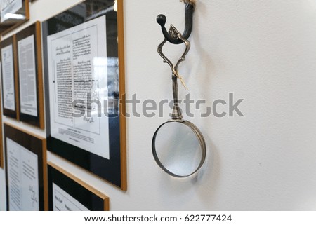 history document copies displayed on the wall with magnifier