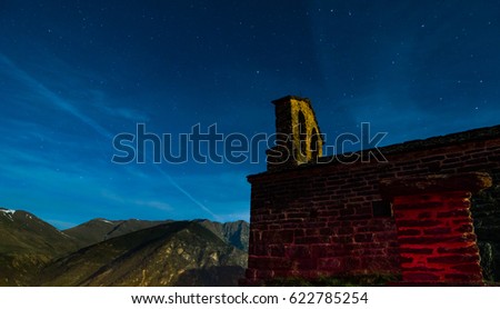 Night photography. Sant Quirc of Durro Romanesque hermitage under the moonlight, Pyrenees, Lleida, Vall de Boi, Catalonia. This church belongs to the UNESCO world heritage site