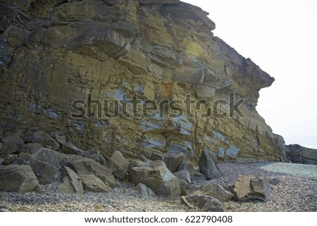 massive high cliff by the sea,