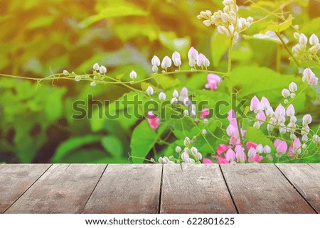 empty wood texture board floor shelf  with flower in nature background with copy space add text