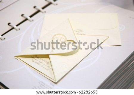 Paper wedding invitation with heart shape