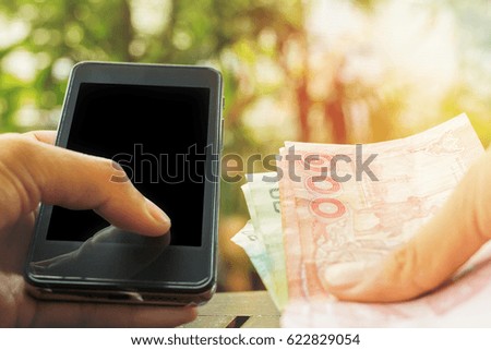 Close up of touch hands holding telephone and financial transactions copy space with sunset background.