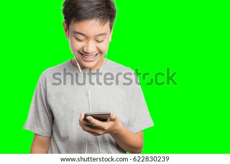 Young man smiling and happy use smartphone. Handsome young man multiracial asian / caucasian model Isolated on green screen chroma key background.