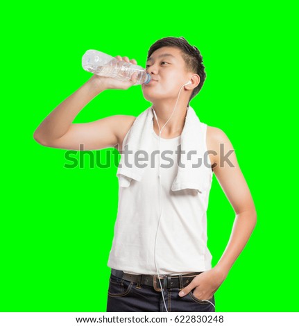 Fitness exercise young man thirsty and drinking water after workout. On isolated green chroma key background.