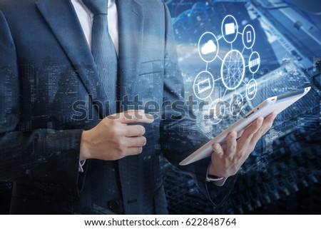 Double exposure of professional businessman connecting network and devices on hand in Cloud technology, communication and business concept