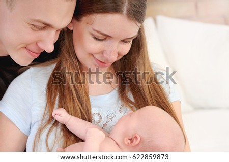family portrait of little cute baby and parents, happy family concept