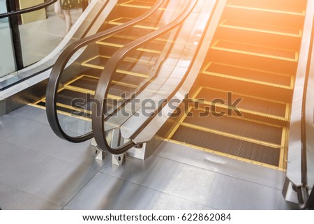 Close up to escalator yellow and gray steel line.