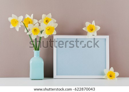 Mockup of picture frame decorated narcissus flowers in vase with empty space for text your blogging and greeting for mother day. 