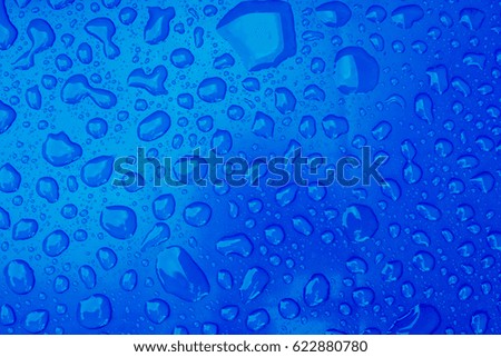 Raindrops on plastic. Blue background.