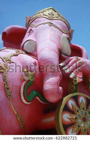 close-up ancient carving of peace Ganesha god, god of success with blue clear sky background